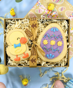 Hand-iced Easter egg and duck biscuits in a craft presentation box spring setting.