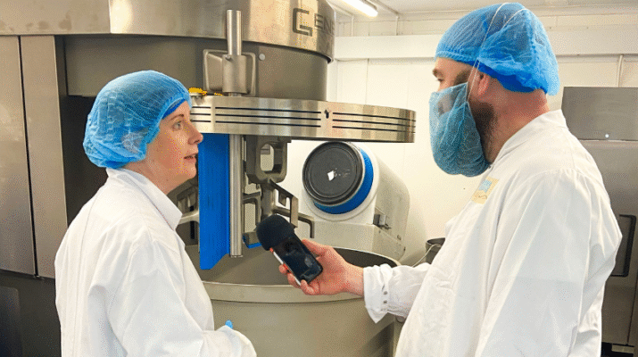 Managing Director Gemma Williams of Original Biscuit Bakers speaking to Adam Green from BBC Radio Shropshire. Large Mixer machine in background.